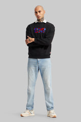 Front view of a man standing in a black sweatshirt with a multi-colored red and blue graphic on the chest.