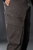Close-up of charcoal grey UNDERRATED cargo pants side with zippered pocket and drawstring waist details.
