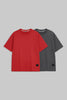Two short-sleeve crewneck t-shirts displayed side by side on a solid gray background. The front t-shirt is a vibrant red, and the t-shirt behind it is dark gray.