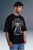 A man wearing a black graphic t-shirt with a white and blue 'Underdogged Jiu Jitsu' print, paired with blue jeans, set against a gray studio background.