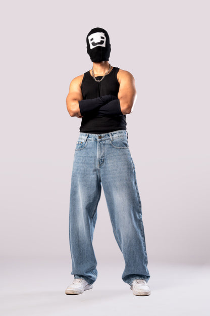 Model wearing Ice Blue Wash baggy denim jeans, black tank top, and black balaclava.