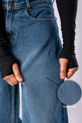 Close-up of the denim's waist, belt loops, and front pocket details.