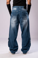 Full-body back view of a person wearing light-wash blue baggy cargo jeans, showing the back pockets and faded details.