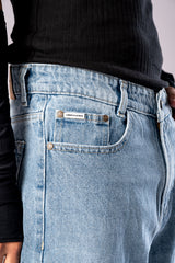 Close-up of the front pocket and waistband detail on Ice Blue Wash baggy denim jeans.