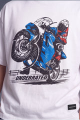 White short-sleeve graphic T-shirt featuring a large front print of a blue and red motorcycle with a rider and the word 'UNDERRATED' below it.