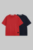 Two short-sleeve crewneck t-shirts displayed side by side on a solid gray background. The front t-shirt is a vibrant red, and the t-shirt behind it is navy blue.