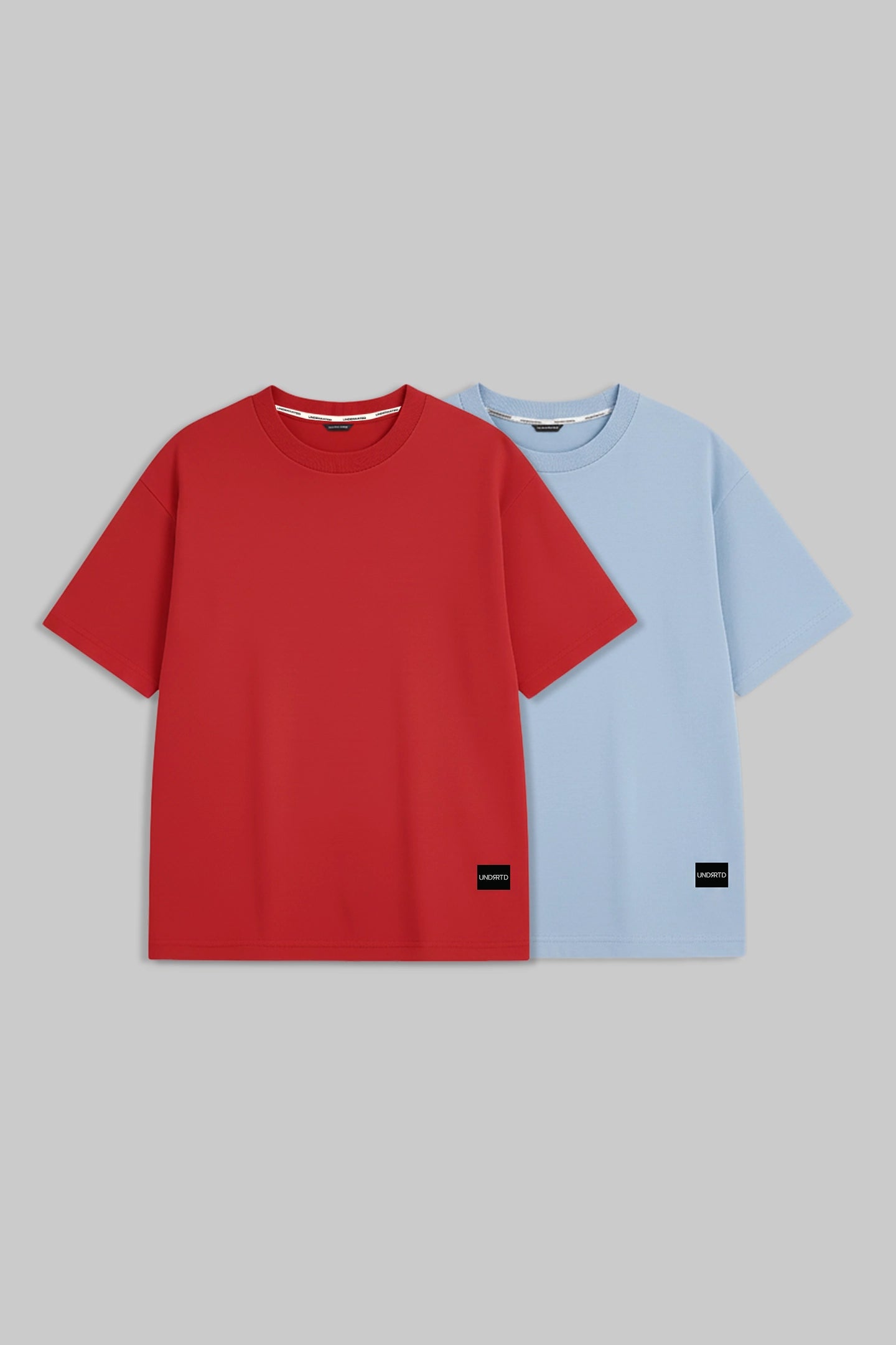 Two short-sleeve crewneck t-shirts displayed side-by-side on a solid.