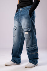 Angled side view of a person wearing light-wash blue baggy cargo jeans, showing the multiple pockets and loose fit.