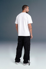 Full Body View of Men Wearing White Oversized T-Shirt with Black Baggy Cargo Pants