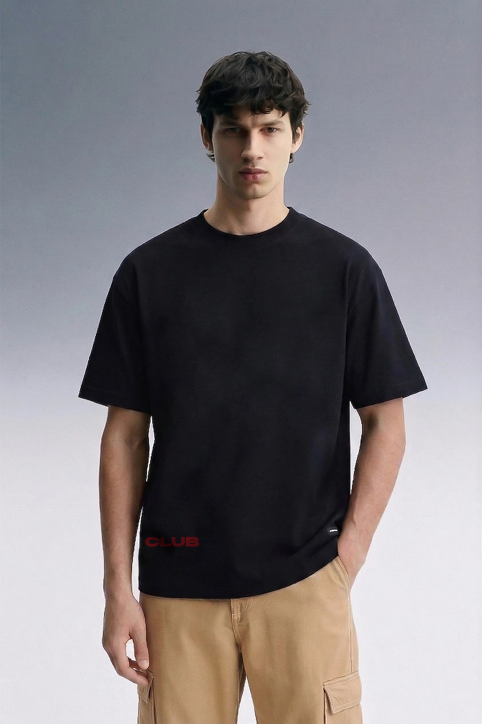 Black Oversized T-Shirt for Men — Front View with Beige Pants | Streetwear Style | URC

