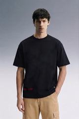 Black Oversized T-Shirt for Men — Front View with Beige Pants | Streetwear Style | URC

