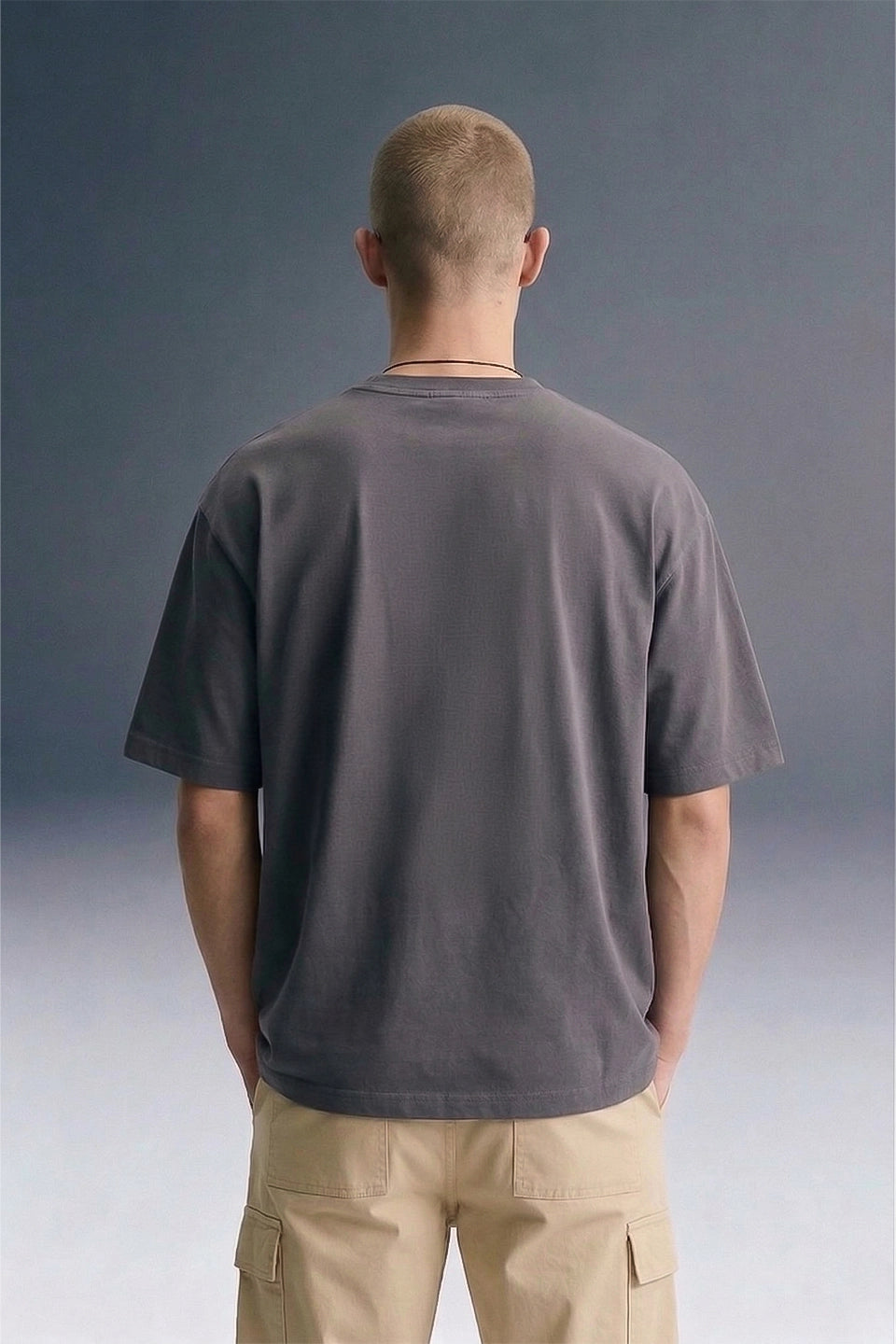 Men's Dark Grey Oversized T-Shirt with Beige Pants — Front View Streetwear | Underrated Club
