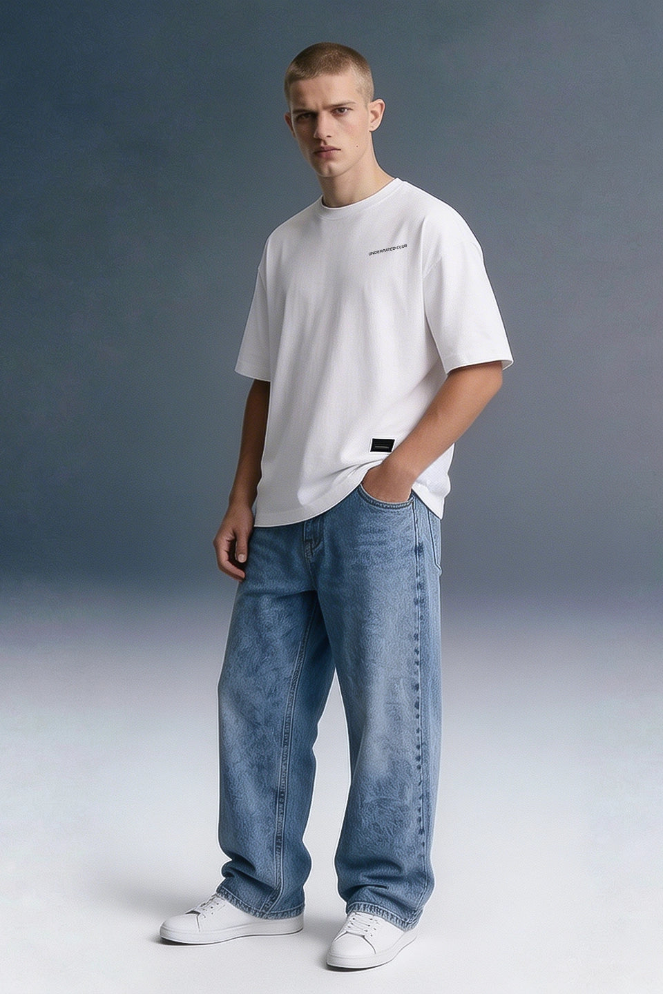 Men's White Oversized Graphic T-Shirt with Baggy Blue Jeans — Full Front View | Underrated Club
