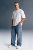 Men's White Oversized Graphic T-Shirt with Baggy Blue Jeans — Full Front View | Underrated Club

