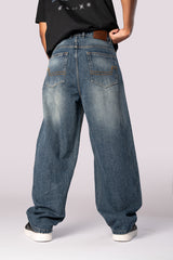 Full-length front view of the dark wash baggy relaxed fit denim jeans.