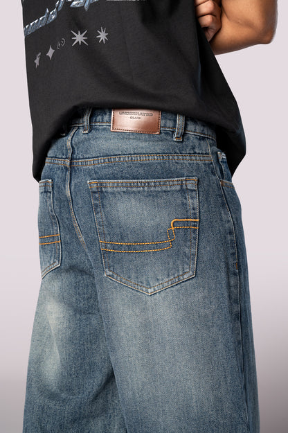 Close-up of the back of the denim jeans, showing the rear pockets and wash detail.