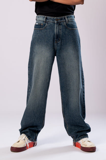Close-up of the front of the dark wash baggy jeans, highlighting the fit.