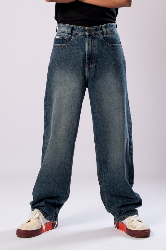 Close-up of the front of the dark wash baggy jeans, highlighting the fit.