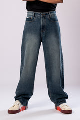 Close-up of the front of the dark wash baggy jeans, highlighting the fit.