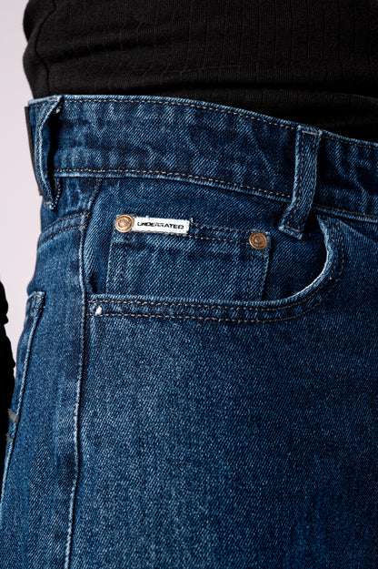 Close-up shot of the front of the dark blue jeans, showing the pocket and button details.