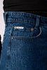 Close-up shot of the front of the dark blue jeans, showing the pocket and button details.