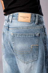 Close-up of the back pocket and Underrated Club leather patch on Ice Blue Wash denim.