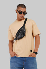 Beige t-shirt model sunglasses crossbody bag side profile jeans casual street style Underrated Club.
