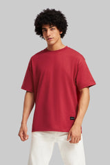 Red t-shirt afro model standing pose white pants vibrant color pop Underrated Club fashion.