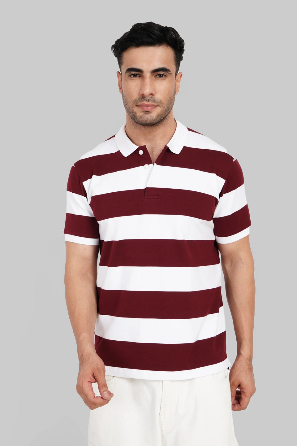 A man wearing a maroon and white horizontally striped polo shirt with a solid white collar.