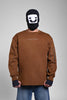 Person in a brown sweatshirt with a small chest logo and a zippered pocket on the sleeve, wearing a black face mask.
