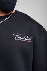 Close-up of black men’s sweatshirt featuring embroidered “Evolving Vision” logo and ribbed crew neck.