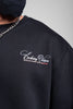 Close-up of black men’s sweatshirt featuring embroidered “Evolving Vision” logo and ribbed crew neck.