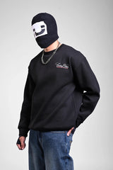 Person in a black sweatshirt featuring white cursive 