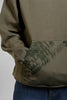 Side view of an olive green hoodie pocket featuring 