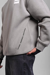 Close-up of a grey Underrated Club sweatshirt featuring 