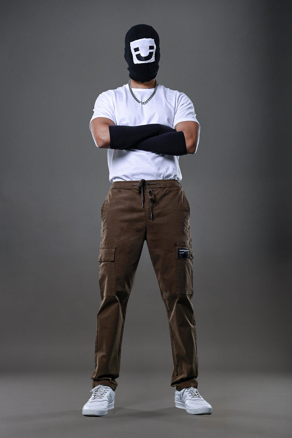 Light grey UNDERRATED CLUB drawstring cargo pants, angled pose on model 