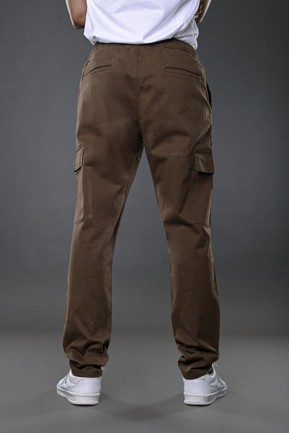 Light grey UNDERRATED CLUB cargo pants, full front model shot with hands on hips.