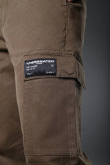 Close-up of brown UNDERRATED CLUB cargo pants thigh pocket with 