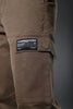 Close-up of brown UNDERRATED CLUB cargo pants thigh pocket with 