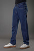 Man dynamic walking pose dark blue slim fit jeans showing movement.
