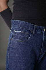Man right three-quarter view dark blue slim jeans, casual relaxed pose.