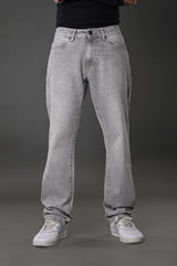 Underrated Club grey wash baggy jeans front full body model black top white sneakers casual fit urban vibe.
