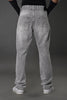 Men's grey baggy jeans full rear view model pose white sneakers gray background street style.
