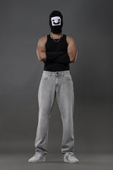 Underrated Club grey baggy jeans front model black balaclava tank top urban streetwear white sneakers.
