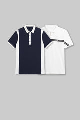 Flat lay of two polo shirts in navy blue and white, each featuring a diagonal contrasting chest panel.