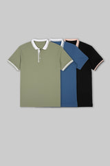 Flat lay of three folded polo shirts in olive green, navy blue, and black, each with white collar accents.