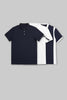 Flat lay of two folded polo shirts in navy blue and white, featuring contrasting side panel designs.