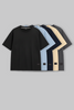 UNDERRATED oversized t-shirts quintet in black, light blue, navy, beige, and grey colors with brand tags against grey background - men's streetwear collection.
