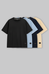 UNDERRATED oversized t-shirts in black, light blue, navy, and beige colors with brand tags against grey background - men's streetwear collection.