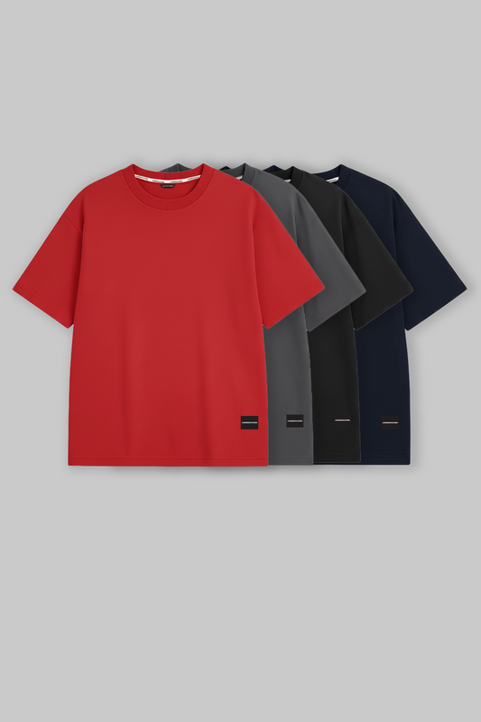 Four oversized UNDERRATED t-shirts in red, grey, black, navy colors displayed against grey background with brand logo tags - men's streetwear essentials.
